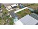 Aerial view of the backyard with a fire pit, green space, storage shed, and a privacy fence at 1790 Pomelo Dr, Venice, FL 34293