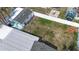 An aerial view of a spacious backyard featuring mature trees and lush greenery, perfect for outdoor activities at 1790 Pomelo Dr, Venice, FL 34293