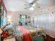 Inviting bedroom with tropical bedding, ceiling fan, and closet at 1790 Pomelo Dr, Venice, FL 34293