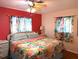 Inviting bedroom with tropical bedding, colorful walls, and hardwood floors at 1790 Pomelo Dr, Venice, FL 34293