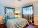 Charming bedroom with a seashell-shaped headboard and tropical themed window coverings at 1790 Pomelo Dr, Venice, FL 34293