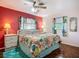 Inviting bedroom with tropical bedding, bright walls, and hardwood floors at 1790 Pomelo Dr, Venice, FL 34293