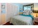 Bright bedroom featuring coastal decor, a large closet, and hardwood floors at 1790 Pomelo Dr, Venice, FL 34293