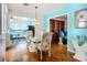 This home features an elegant dining area with a glass table and beautiful accents at 1790 Pomelo Dr, Venice, FL 34293