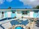 Unique front yard landscaping with decorative stones, statues, and eye-catching color scheme at 1790 Pomelo Dr, Venice, FL 34293