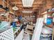 This cluttered garage features wood framing and shelving, providing ample storage and workshop potential at 1790 Pomelo Dr, Venice, FL 34293