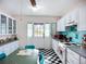 Quaint kitchen with white cabinets, checkerboard flooring, and vintage appliances offers nostalgic appeal at 1790 Pomelo Dr, Venice, FL 34293