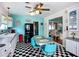 Nostalgic kitchen features turquoise accents, checkered floors, and flows into adjacent living area at 1790 Pomelo Dr, Venice, FL 34293