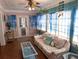 Bright living room with a floral sofa, blue accents, and a seaside feel at 1790 Pomelo Dr, Venice, FL 34293