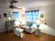 Cozy living room featuring wood floors, ceiling fan, and a comfortable sofa with throw pillows at 1790 Pomelo Dr, Venice, FL 34293
