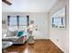 Bright living room with parquet flooring, patterned sofa and a glass coffee table at 1790 Pomelo Dr, Venice, FL 34293