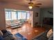 Spacious living room featuring wood floors, ceiling fan, and comfortable sofa arrangement at 1790 Pomelo Dr, Venice, FL 34293