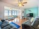 Bright living room features hardwood floors, ceiling fan, and a cheerful, colorful design at 1790 Pomelo Dr, Venice, FL 34293