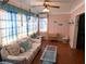 Cozy living room featuring seaside-themed decor, pink walls, and lots of natural light at 1790 Pomelo Dr, Venice, FL 34293