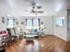 Inviting living room with parquet floors, ceiling fan, and comfortable seating arrangement at 1790 Pomelo Dr, Venice, FL 34293