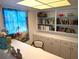 Cozy office space with built-in shelves and cabinets, complemented by a bright window and chair at 1790 Pomelo Dr, Venice, FL 34293