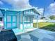 Exterior of shed with covered patio area and blue trim under a bright, sunny sky at 1790 Pomelo Dr, Venice, FL 34293
