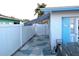 Side yard with a white fence, patio, and shed in a well-maintained outdoor space at 1790 Pomelo Dr, Venice, FL 34293