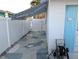 Side yard with a white fence, patio, and shed in a well-maintained outdoor space at 1790 Pomelo Dr, Venice, FL 34293