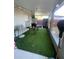 Cozy covered patio featuring artificial turf, ideal for outdoor relaxation and entertainment at 3307 W Saint John St, Tampa, FL 33607