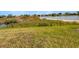 Spacious backyard with lush grass and views of the serene lake, offering a tranquil retreat at 5154 51St W Ln, Bradenton, FL 34210