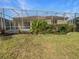 Manicured backyard featuring a lush green lawn and privacy landscaping surrounding the screened lanai at 5154 51St W Ln, Bradenton, FL 34210