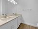 Well-lit bathroom featuring a double vanity with modern faucets and neutral countertops at 5154 51St W Ln, Bradenton, FL 34210