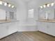 Luxury bathroom with dual vanities, a large soaking tub, and elegant lighting fixtures at 5154 51St W Ln, Bradenton, FL 34210