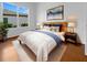 Bright bedroom featuring a wood bed frame, white bedding, blue accents, and modern nightstands with lamps at 5154 51St W Ln, Bradenton, FL 34210