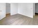 Bright bedroom with wood-look floors, closet space, and access to other areas of the home at 5154 51St W Ln, Bradenton, FL 34210