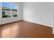 An empty bedroom featuring new, modern vinyl flooring and a beautiful view out the window at 5154 51St W Ln, Bradenton, FL 34210