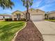 Charming single-story home with a well-manicured lawn and a spacious two-car garage at 5154 51St W Ln, Bradenton, FL 34210