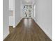 A long hallway featuring new, modern vinyl flooring leading to the home's entryway at 5154 51St W Ln, Bradenton, FL 34210