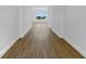 A long hallway featuring new, modern vinyl flooring and a beautiful view out the window at 5154 51St W Ln, Bradenton, FL 34210