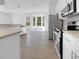 Bright kitchen features stainless appliances, white cabinets, and a breakfast nook with large windows at 5154 51St W Ln, Bradenton, FL 34210
