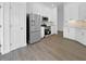 Well-lit kitchen showcasing stainless steel appliances, white cabinetry, and modern flooring at 5154 51St W Ln, Bradenton, FL 34210