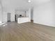 Bright, open living area with neutral paint, light wood floors, and an adjacent kitchen at 5154 51St W Ln, Bradenton, FL 34210