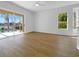 Living room with a view of the pool area through sliding glass doors and bright sunlight at 5154 51St W Ln, Bradenton, FL 34210