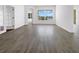 An empty living room featuring new, modern vinyl flooring and a beautiful view out the window at 5154 51St W Ln, Bradenton, FL 34210
