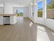 Open-concept living area with stainless appliances and a view of the pool and lanai at 5154 51St W Ln, Bradenton, FL 34210