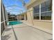 Enclosed patio area with a pool, light-colored flooring, and a view of the outdoor landscape at 5154 51St W Ln, Bradenton, FL 34210