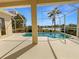 Screened-in pool area with a clear view of the water and a glimpse of the lake at 5154 51St W Ln, Bradenton, FL 34210