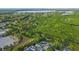 Aerial view of home near the water surrounded by dense tropical vegetation at 7490 Locust Ne St, St Petersburg, FL 33702