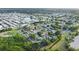 An aerial view showcases a neighborhood near the water surrounded by dense tropical vegetation at 7490 Locust Ne St, St Petersburg, FL 33702
