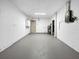 A clean basement with painted walls and floor, utility hookups, and access doors is ready for storage at 7490 Locust Ne St, St Petersburg, FL 33702