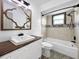 Bathroom featuring a decorative mirror, pedestal sink, and a bathtub with tiled wall and a shower curtain at 7490 Locust Ne St, St Petersburg, FL 33702