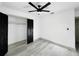 Bright bedroom featuring a modern ceiling fan and large closet doors at 7490 Locust Ne St, St Petersburg, FL 33702