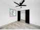 Bright bedroom with modern ceiling fan and large closet doors at 7490 Locust Ne St, St Petersburg, FL 33702