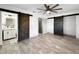Spacious bedroom with stylish barn doors, modern flooring, and neutral decor at 7490 Locust Ne St, St Petersburg, FL 33702