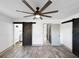 Bedroom showcasing modern decor, a ceiling fan, and a rustic barn door at 7490 Locust Ne St, St Petersburg, FL 33702